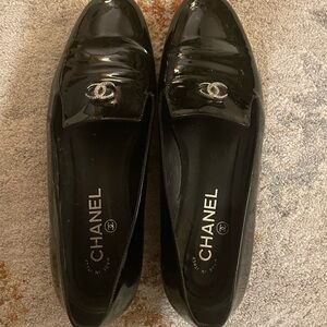 CHANEL Glossy Black Patent Loafers with Silver Logo